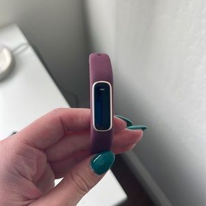 Purple/fuchsia Garmin watch and activity tracker